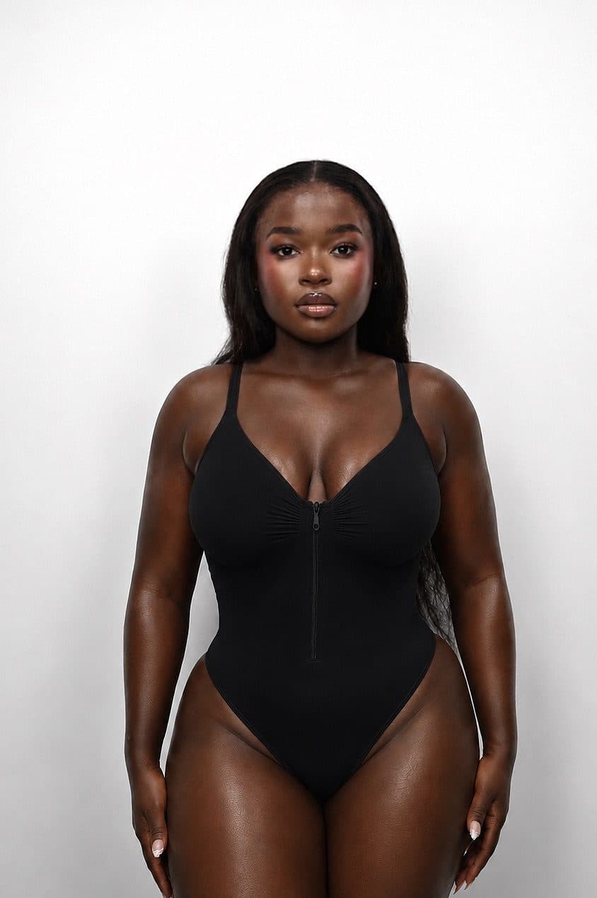 Front view of a model wearing the Classic Black IYRA Shape zip bodysuit.